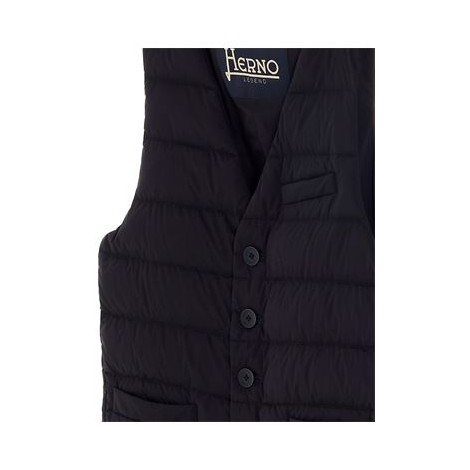 Gilet da uomo di Herno Legend, colore blu. Realizzato nel tessuto iconico Herno: materiale in nylon 20 denari a prova di piuma. Questo materiale ha un trattamento resistente alla pioggia (WR). Modello opaco, imbottito, con taschino filetto al petto e